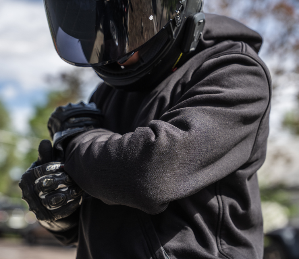 Motorcycle rider wearing Cased protective hoodie with CE Level 2 certified pads at the shoulders and elbows.