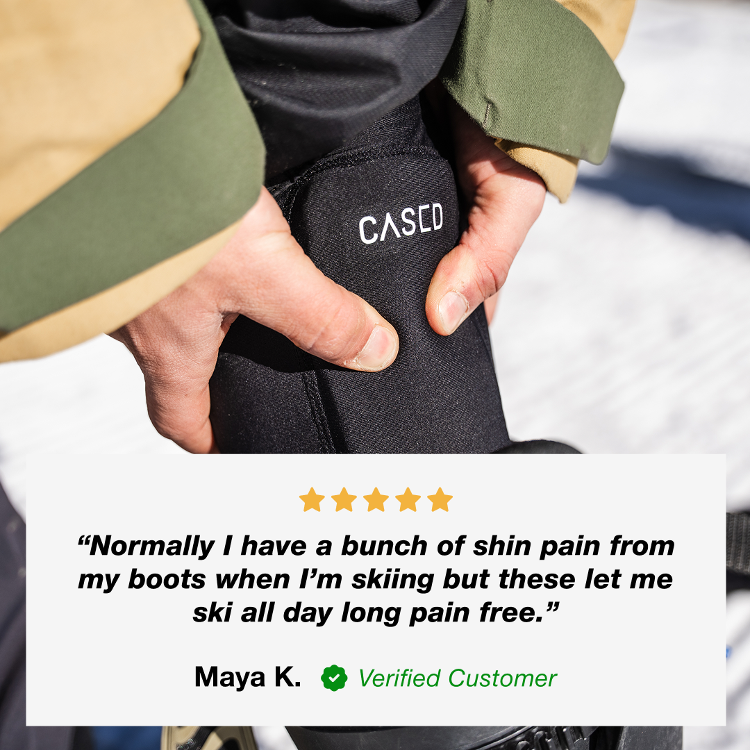 Photo of person wearing Cased ski shin guard with a five-star customer review about the elimination of pain from ski boots.